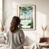 03 - Framed Brisbane Streets Beach Watercolor Wall Art - In Living Room with Woman Looking at it - Portrait
