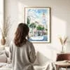 03 - Framed Charleston SC Watercolor Wall Art - In Living Room with Woman Looking at it - Portrait