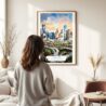 03 - Framed Houston Texas Watercolor Wall Art - In Living Room with Woman Looking at it - Portrait