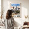 03 - Framed Melbourne Watercolor Wall Art - In Living Room with Woman Looking at it - Portrait