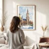 03 - Framed Munich Marienplatz Watercolor Wall Art - In Living Room with Woman Looking at it - Portrait