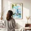 03 - Framed Orlando Florida Watercolor Wall Art - In Living Room with Woman Looking at it - Portrait