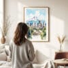 03 - Framed Portland Oregon Watercolor Wall Art - In Living Room with Woman Looking at it - Portrait