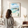 03 - Framed San Diego Beach Watercolor Wall Art - In Living Room with Woman Looking at it - Portrait