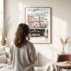 03 - Framed Seattle Pike Place Market Watercolor Wall Art - In Living Room with Woman Looking at it - Portrait