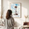03 - Framed Seattle Space Needle Watercolor Wall Art - In Living Room with Woman Looking at it - Portrait