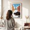 03 - Framed Seoul N Seoul Tower Korea Watercolor Wall Art - In Living Room with Woman Looking at it - Portrait