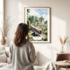 03 - Framed Sri Lanka Train Watercolor Wall Art - In Living Room with Woman Looking at it - Portrait