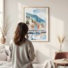 Framed Bergen Norway Waterfront Watercolor Wall Art - In Living Room with Woman Looking at it - Portrait