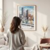 Framed Boston Harbor Watercolor Wall Art - In Living Room with Woman Looking at it - Portrait