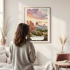 Framed Colorado Springs Watercolor Wall Art – In Living Room with Woman Looking at it – Portrait