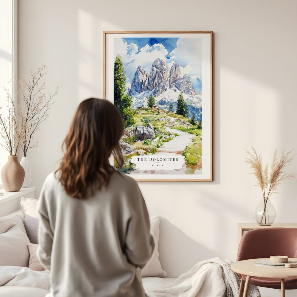 Framed Dolomites Hiking Watercolor Wall Art - In Living Room with Woman Looking at it - Portrait Framed Dolomites Hiking Watercolor Wall Art - In Living Room with Woman Looking at it - Portrait