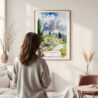Framed Dolomites Hiking Watercolor Wall Art - In Living Room with Woman Looking at it - Portrait