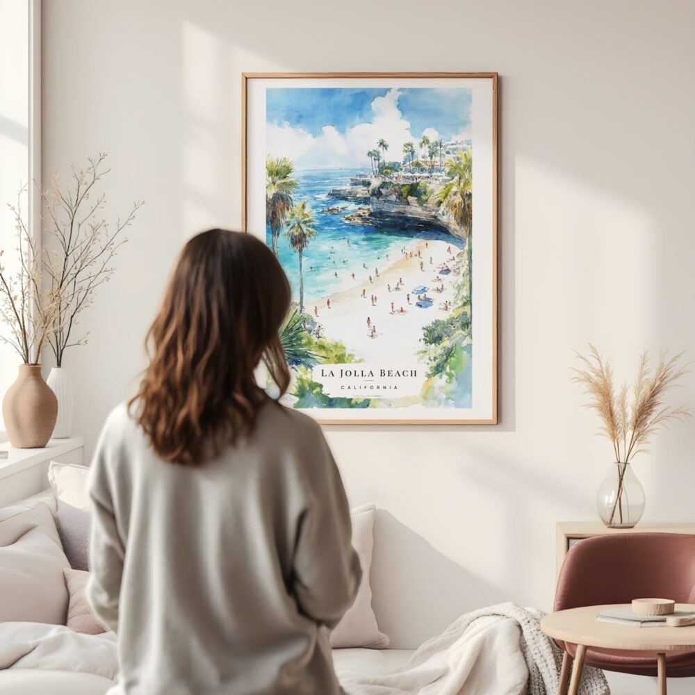 Framed La Jolla Beach Watercolor Wall Art - In Living Room with Woman Looking at it - Portrait Framed La Jolla Beach Watercolor Wall Art - In Living Room with Woman Looking at it - Portrait