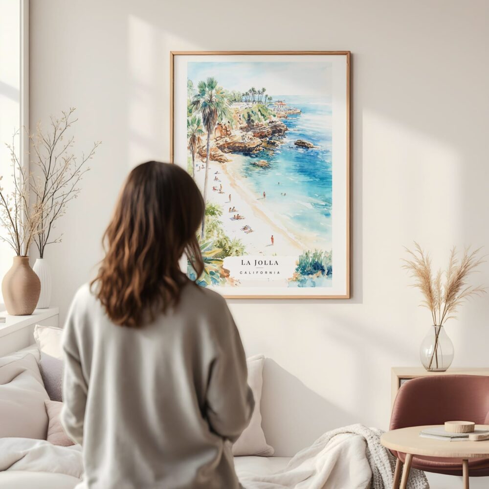 Framed La Jolla Cove Watercolor Wall Art - In Living Room with Woman Looking at it - Portrait Framed La Jolla Cove Watercolor Wall Art - In Living Room with Woman Looking at it - Portrait
