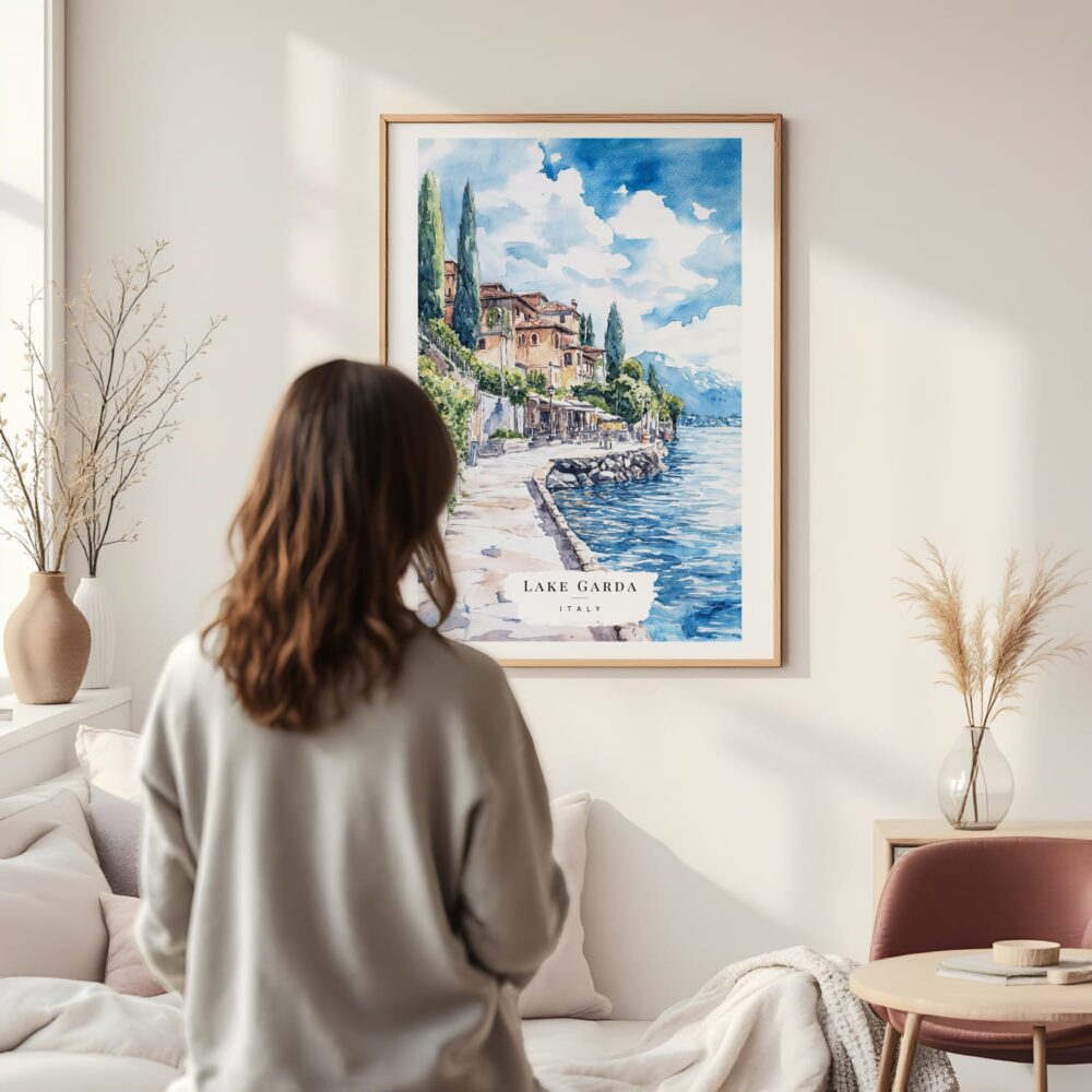 Framed Lake Garda Watercolor Wall Art - In Living Room with Woman Looking at it - Portrait Framed Lake Garda Watercolor Wall Art - In Living Room with Woman Looking at it - Portrait