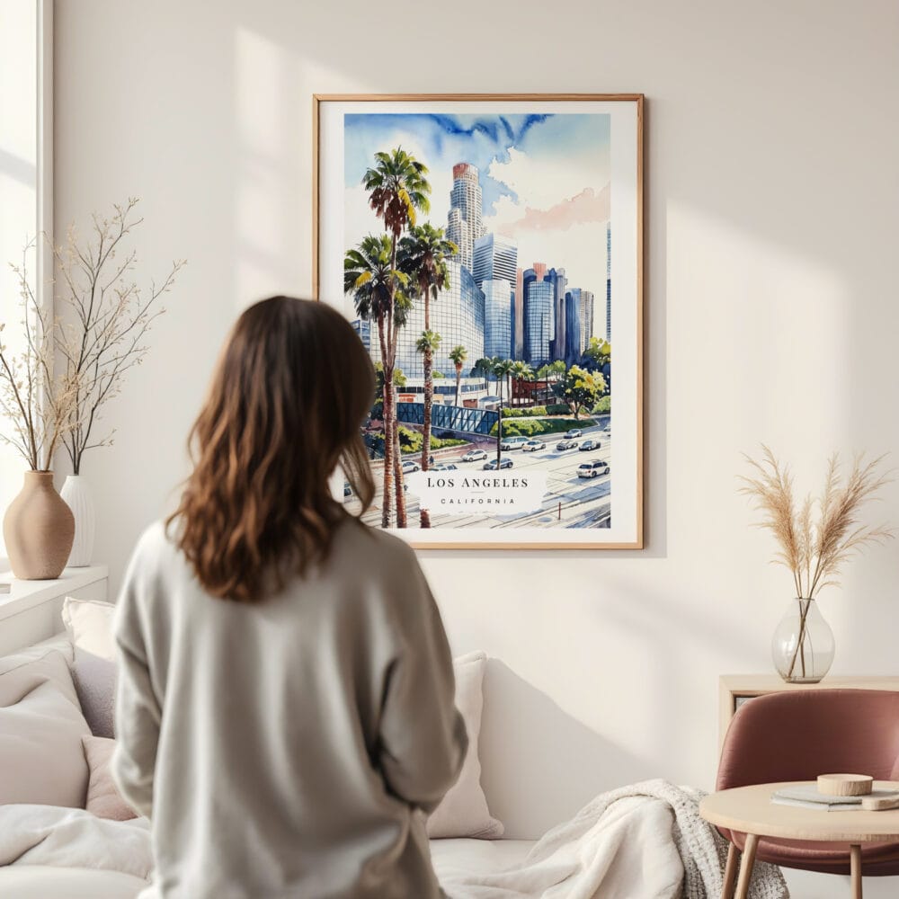 Framed Los Angeles Downtown Watercolor Wall Art - In Living Room with Woman Looking at it - Portrait Framed Los Angeles Downtown Watercolor Wall Art - In Living Room with Woman Looking at it - Portrait