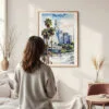 Framed Los Angeles Downtown Watercolor Wall Art - In Living Room with Woman Looking at it - Portrait