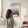 Framed Los Angeles Skyline Watercolor Wall Art - In Living Room with Woman Looking at it - Portrait