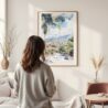 Framed Medellin Colombia Skyline Watercolor Wall Art - In Living Room with Woman Looking at it - Portrait