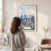 Framed Montreal Skyline Watercolor Wall Art - In Living Room with Woman Looking at it - Portrait