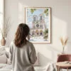 Framed Notre Dame Cathedral Watercolor Wall Art - In Living Room with Woman Looking at it - Portrait