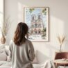 Framed Notre Dame Cathedral Watercolor Wall Art - In Living Room with Woman Looking at it - Portrait