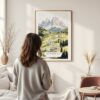 Framed The Dolomites Watercolor Wall Art - In Living Room with Woman Looking at it - Portrait