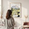 Framed The Dolomites Watercolor Wall Art - In Living Room with Woman Looking at it - Portrait