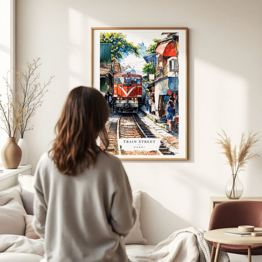 03 - Framed Hanoi Train Street Vietnam Watercolor Wall Art - In Living Room with Woman Looking at it - Portrait.jpg 03 - Framed Hanoi Train Street Vietnam Watercolor Wall Art - In Living Room with Woman Looking at it - Portrait.jpg