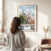 03 - Framed Strasbourg France Watercolor Wall Art - In Living Room with Woman Looking at it - Portrait.jpg