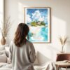 03 - Framed The Bahamas Watercolor Wall Art - In Living Room with Woman Looking at it - Portrait.jpg