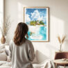 03 - Framed The Bahamas Watercolor Wall Art - In Living Room with Woman Looking at it - Portrait.jpg