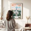 03 - Framed Athens Georgia Watercolor Wall Art - In Living Room with Woman Looking at it - Portrait.jpg