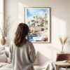 03 - Framed Cascais Portugal Watercolor Wall Art - In Living Room with Woman Looking at it - Portrait.jpg