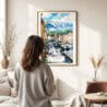 03 - Framed Innsbruck Watercolor Wall Art - In Living Room with Woman Looking at it - Portrait.jpg