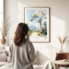 03 - Framed Isalo National Park Watercolor Wall Art - In Living Room with Woman Looking at it - Portrait.jpg