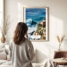 03 - Framed Nazare Portugal Watercolor Wall Art - In Living Room with Woman Looking at it - Portrait.jpg