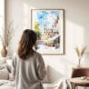 03 - Framed Norwich England Watercolor Wall Art - In Living Room with Woman Looking at it - Portrait.jpg