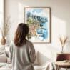 03 - Framed Perast Montenegro Watercolor Wall Art - In Living Room with Woman Looking at it - Portrait.jpg