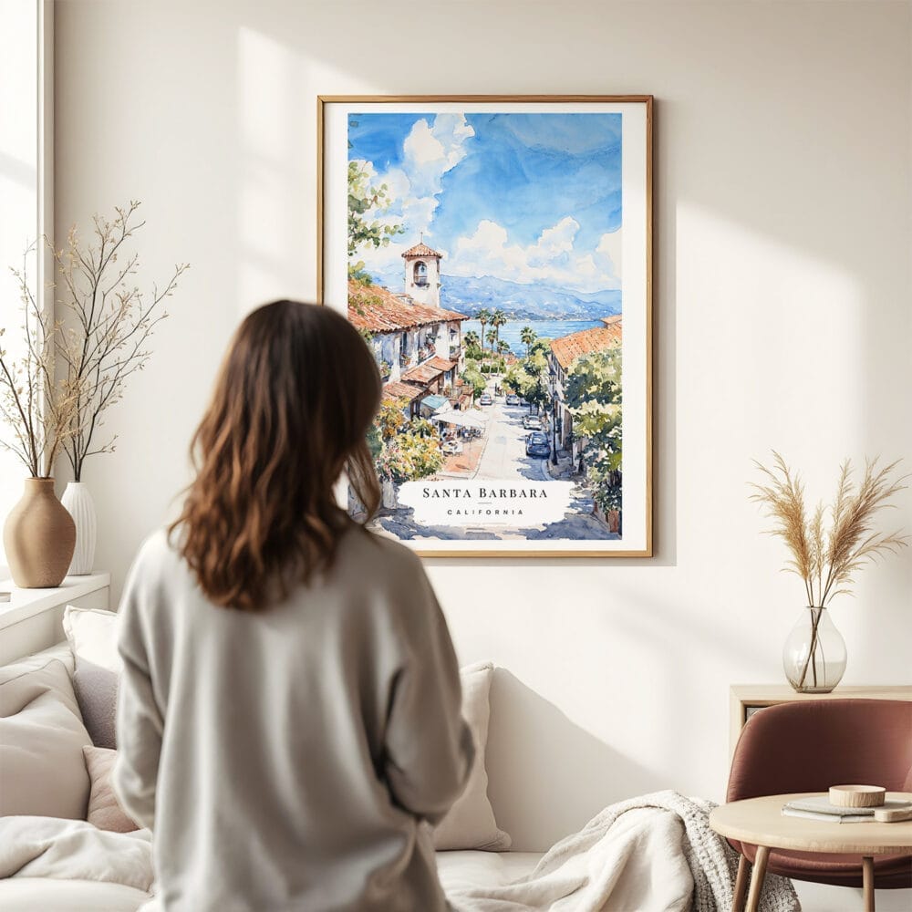 03 - Framed Santa Barbara California Watercolor Wall Art - In Living Room with Woman Looking at it - Portrait.jpg 03 - Framed Santa Barbara California Watercolor Wall Art - In Living Room with Woman Looking at it - Portrait.jpg