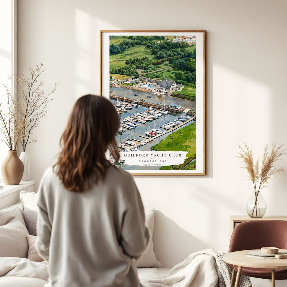 03 - Framed Guilford Connecticut Yacht Club Watercolor Wall Art - In Living Room with Woman Looking at it - Portrait.jpg 03 - Framed Guilford Connecticut Yacht Club Watercolor Wall Art - In Living Room with Woman Looking at it - Portrait.jpg