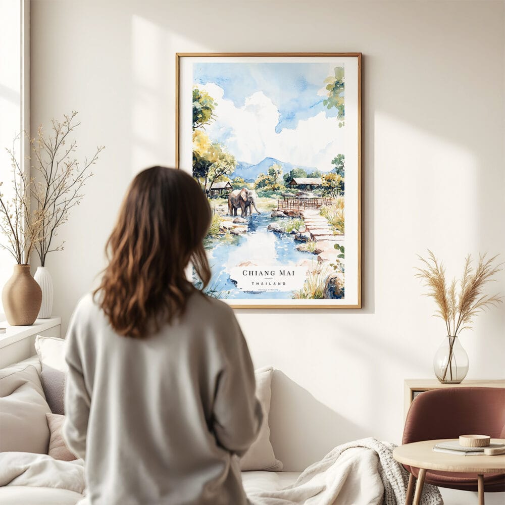 03 - Framed Chiang Mai Elephant Watercolor Wall Art - In Living Room with Woman Looking at it - Portrait.jpg 03 - Framed Chiang Mai Elephant Watercolor Wall Art - In Living Room with Woman Looking at it - Portrait.jpg