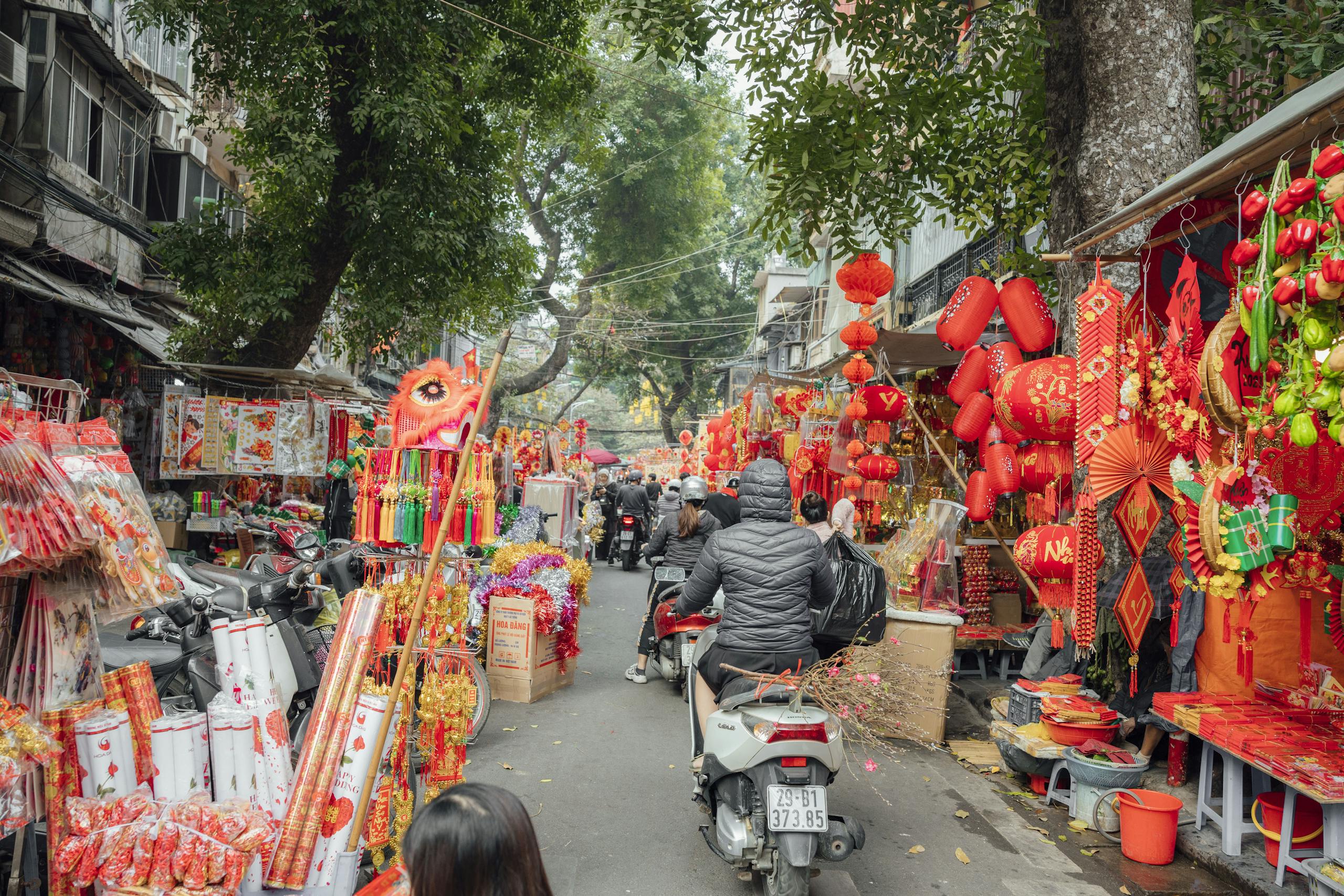 A lively street market filled with colorful decorations for Chinese New Year celebrations.