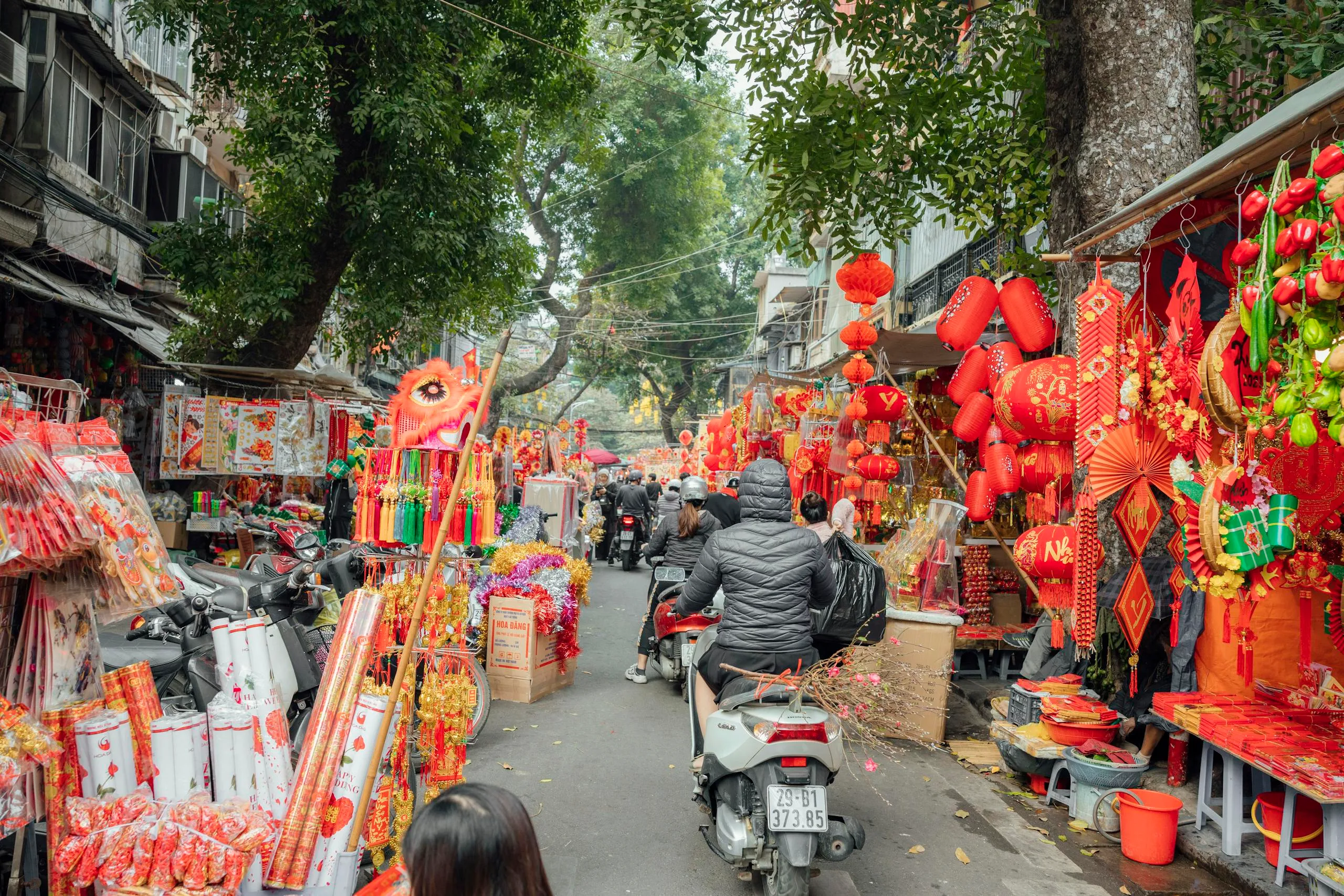 Essential 5-Day Vietnam Itinerary: Explore Vietnam’s Highlights Efficiently 3 A lively street market filled with colorful decorations for Chinese New Year celebrations.