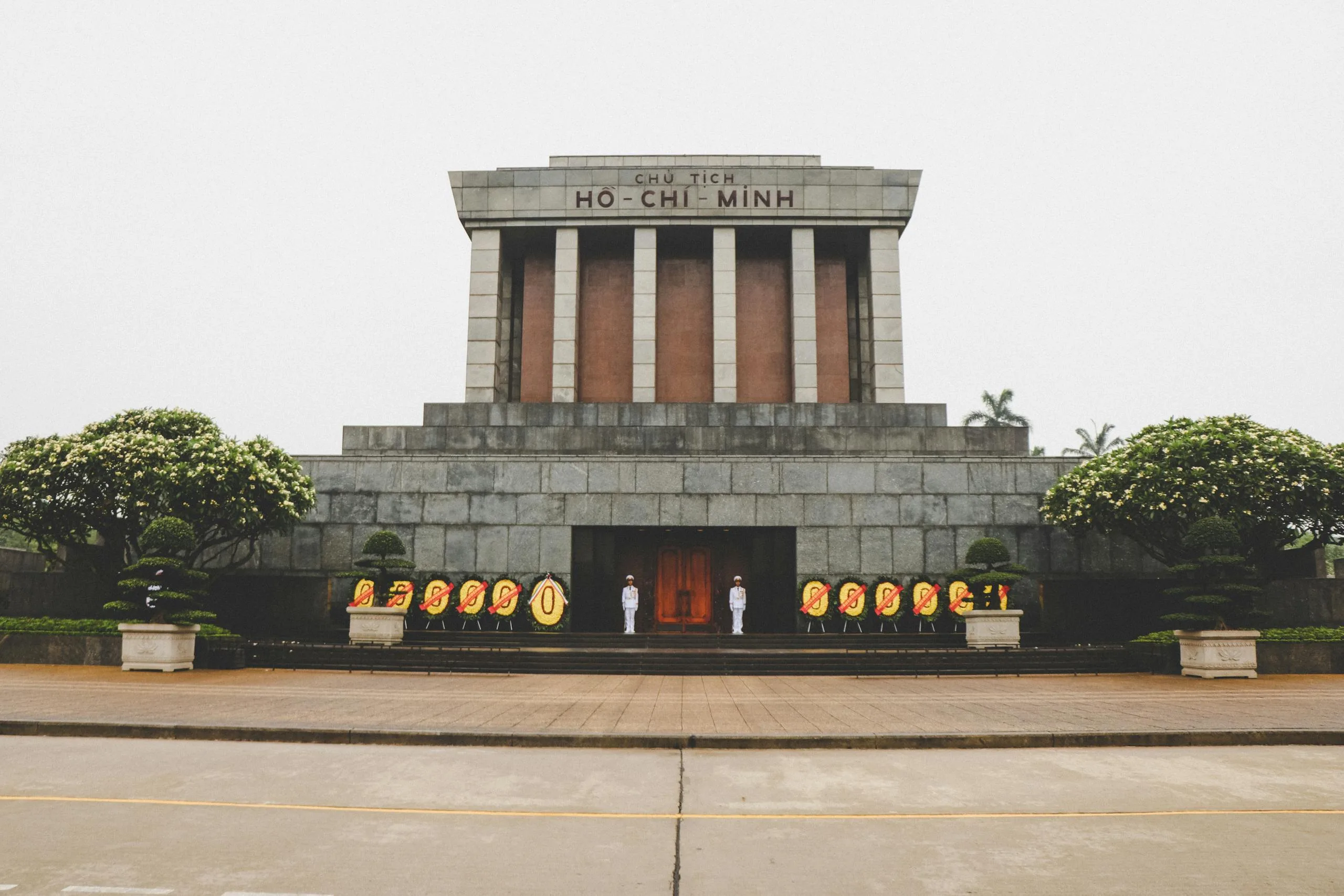 Essential 5-Day Vietnam Itinerary: Explore Vietnam’s Highlights Efficiently 4 Front view of the iconic Ho Chi Minh Mausoleum in Hanoi, Vietnam with guards and floral wreaths.