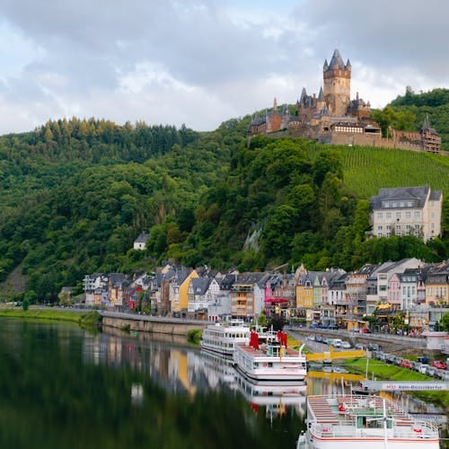 Idyllic landscape of Cochem Castle overlooking Moselle River in Germany.