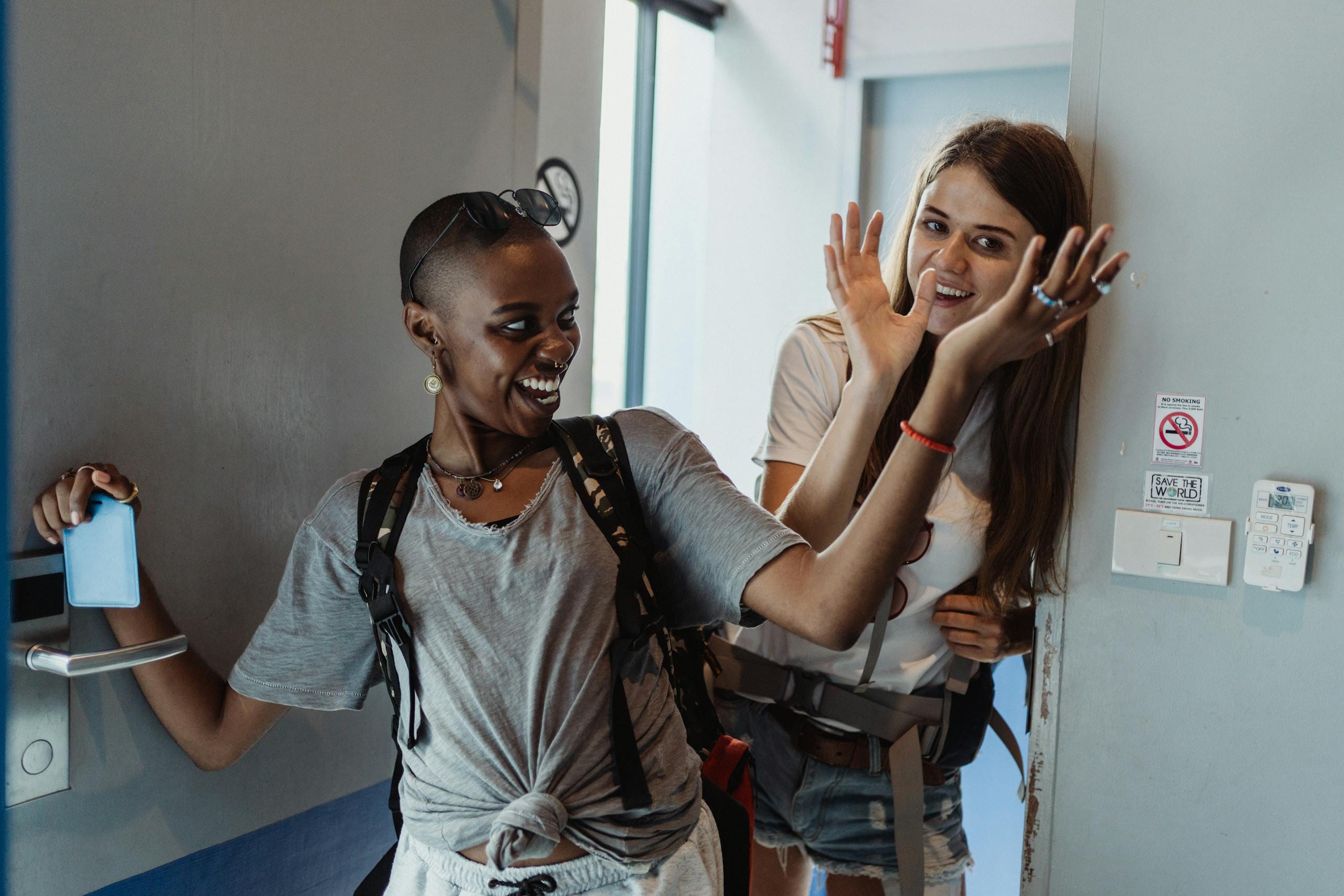Best Cheap Places to Go on Vacation in 2025 — Budget Destinations, Sample Budgets & Money-Saving Hacks 30 Two female travelers joyfully enter a hostel room, ready for adventure.
