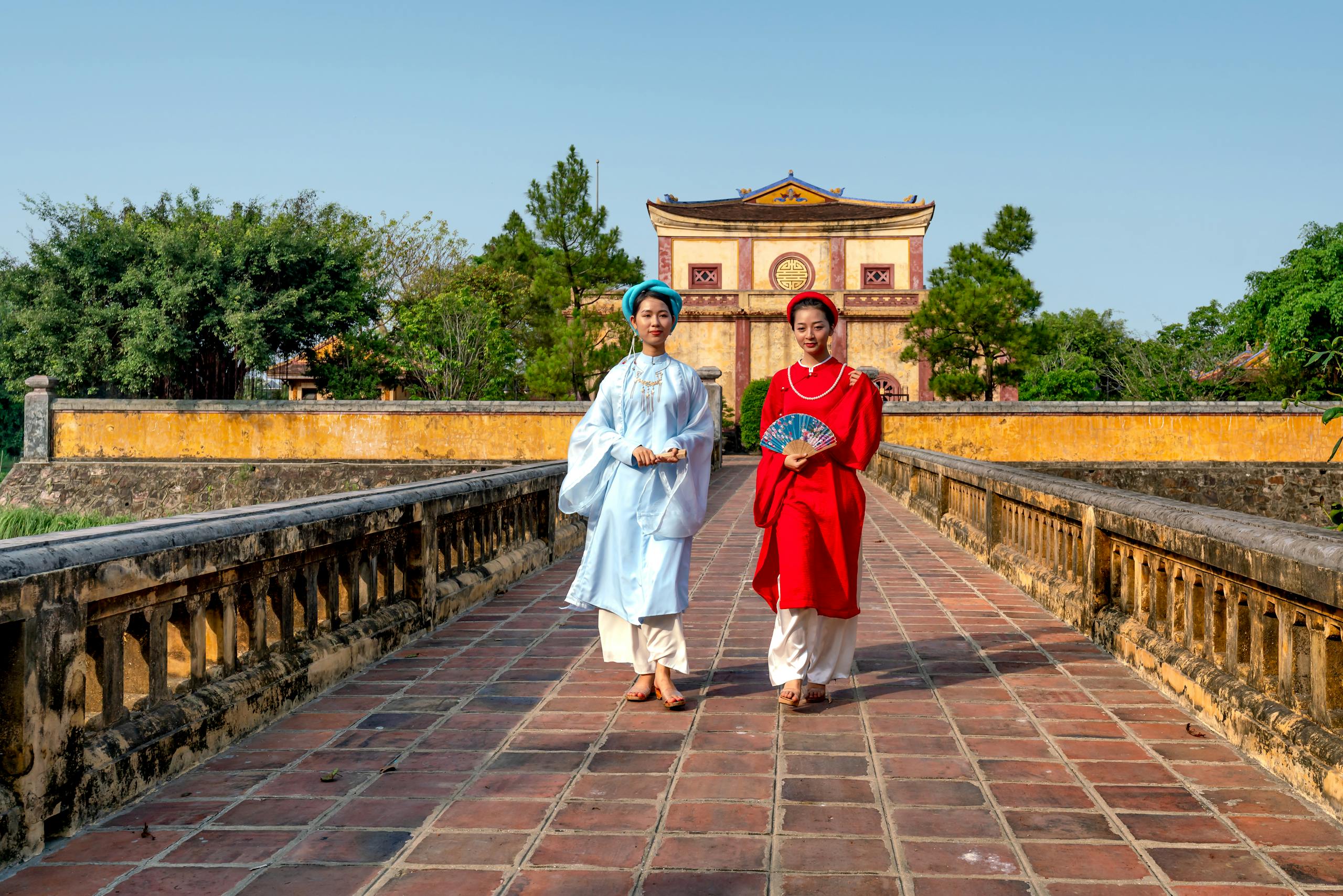 Vietnamese women in traditional clothing at Tang Thu Lau, symbolizing cultural heritage.