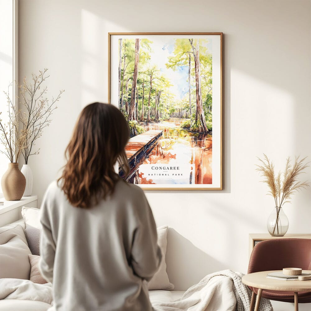 03 - Framed Congaree National Park Watercolor Wall Art - In Living Room with Woman Looking at it - Portrait.jpg 03 - Framed Congaree National Park Watercolor Wall Art - In Living Room with Woman Looking at it - Portrait.jpg